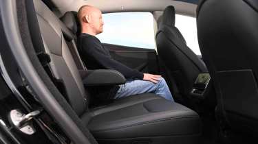 Tesla Model Y - rear seats with Auto Express Chief reviewer, Alex Ingram